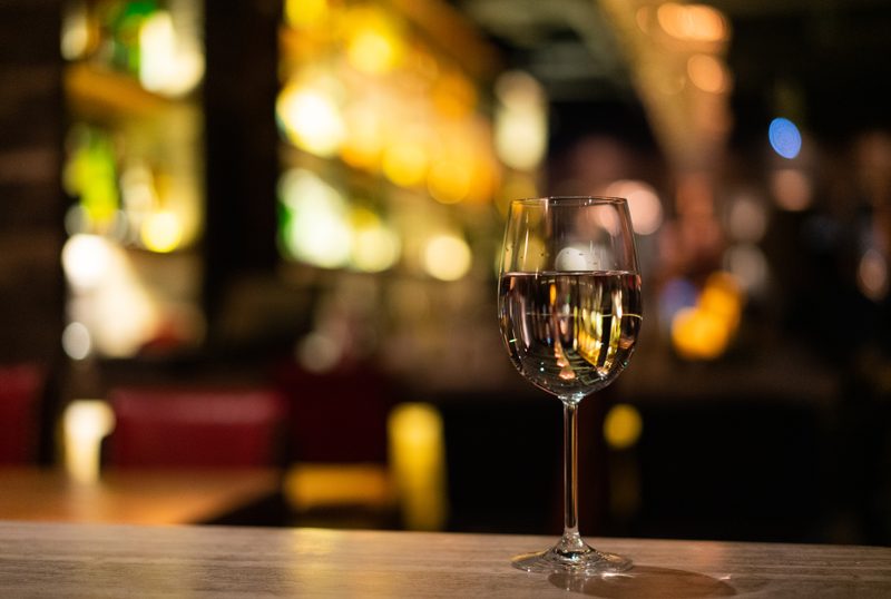 Glass of white wine on bar