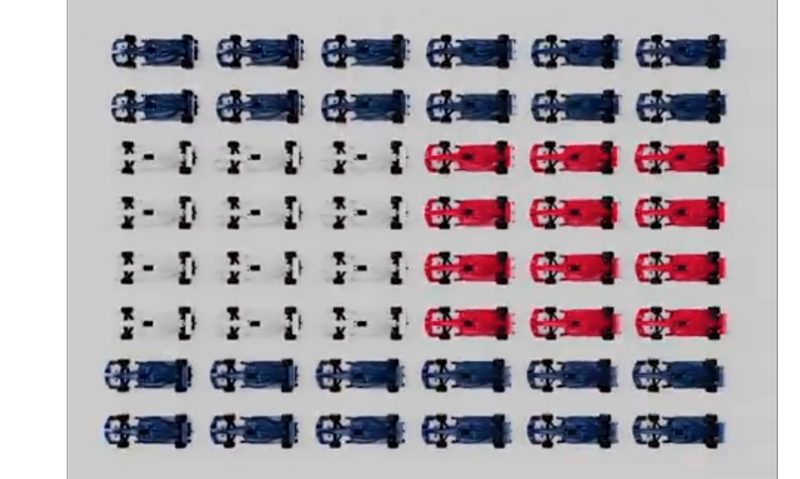 F1 car models arranged in Tommy Hilfiger logo colors.