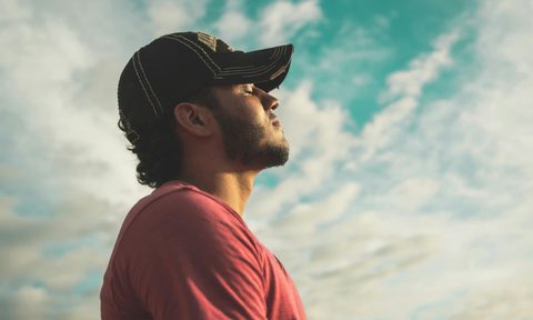 man outside wearing a black hat