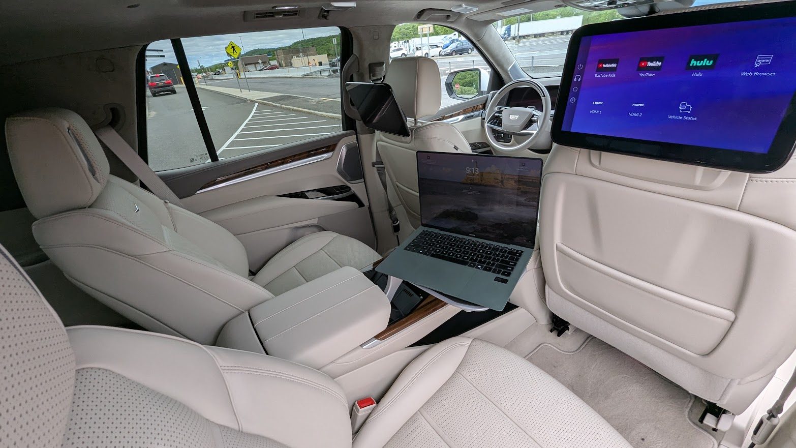 Interior view of a 2025 Cadillac Escalade with a laptop set up
