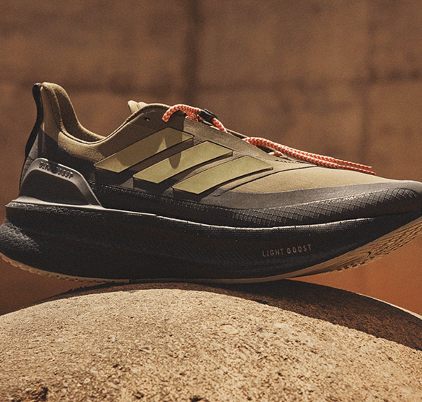 green ultraboost 5 sneaker on concrete