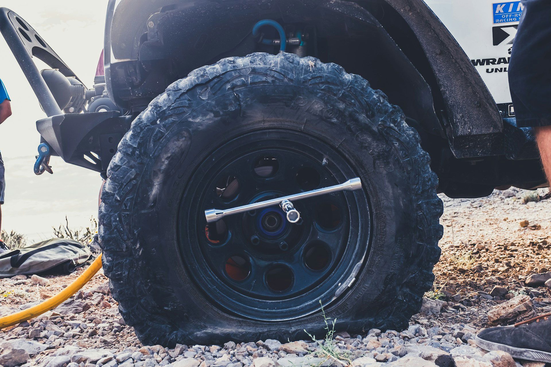 Closeup of a flat tire on a white Jeep Wrangler Unlimited.