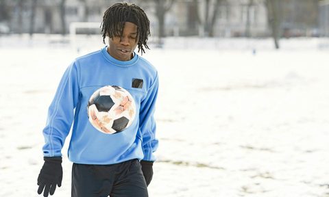 teen playing football