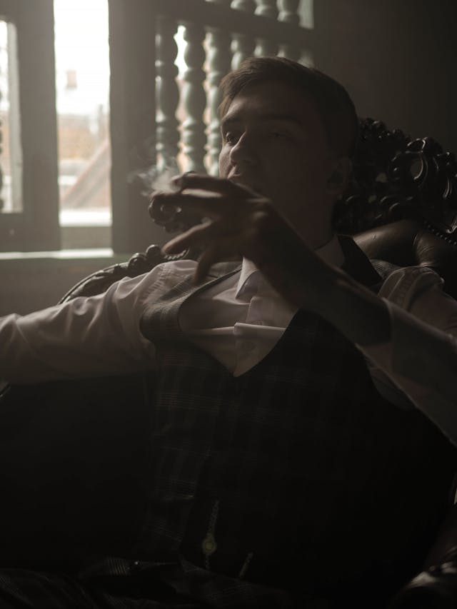 man smoking alone in the dark