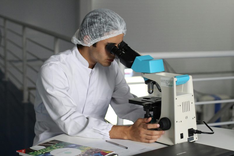 Scientist looking into microscope