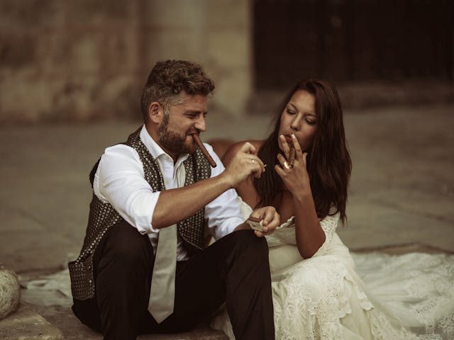 a couple smoking cigars