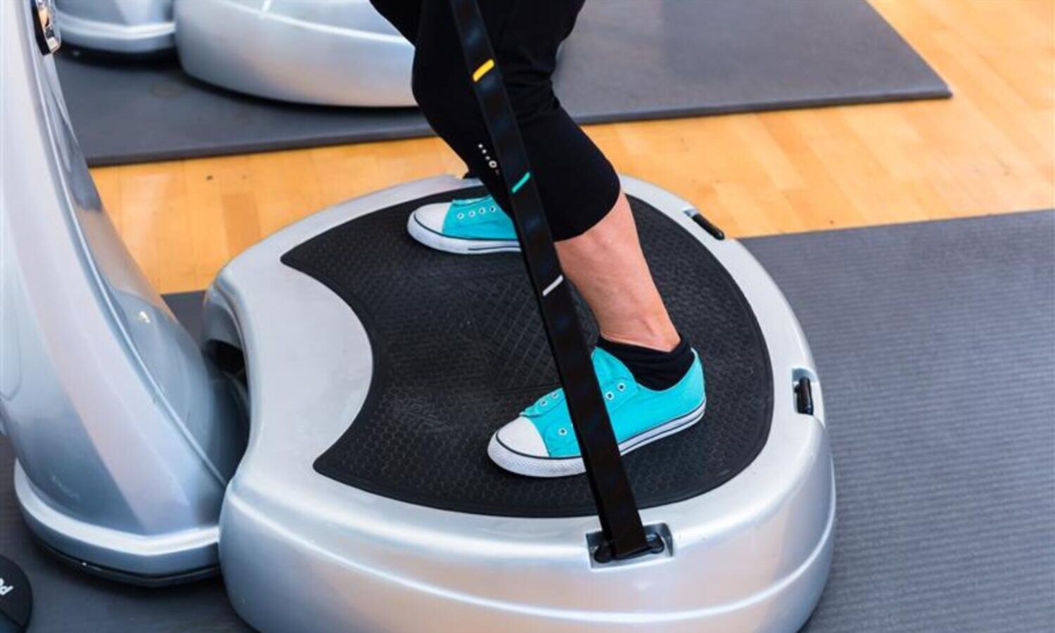 Person standing on vibration plate.