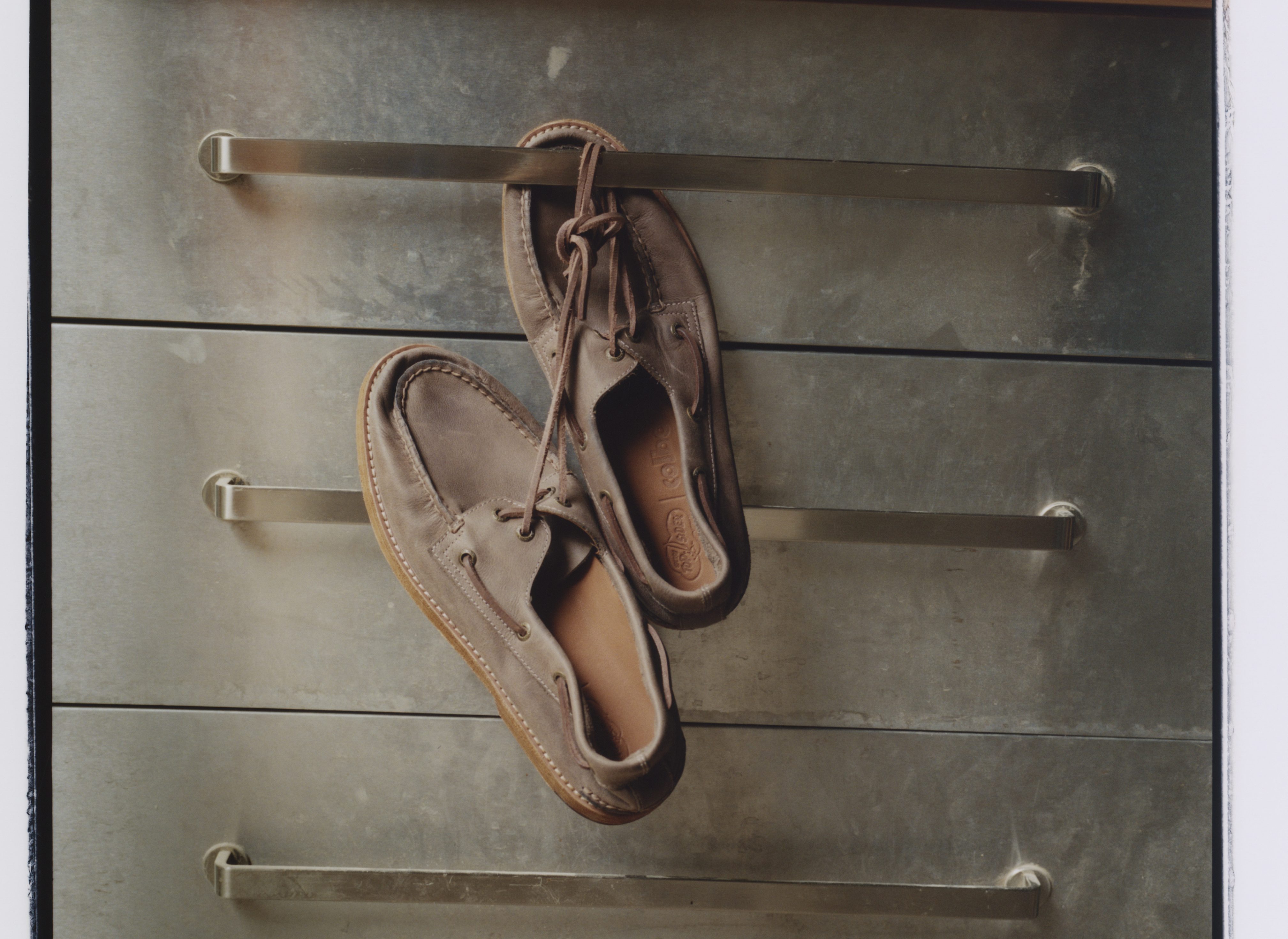 boat shoes hanging from metal cabinet