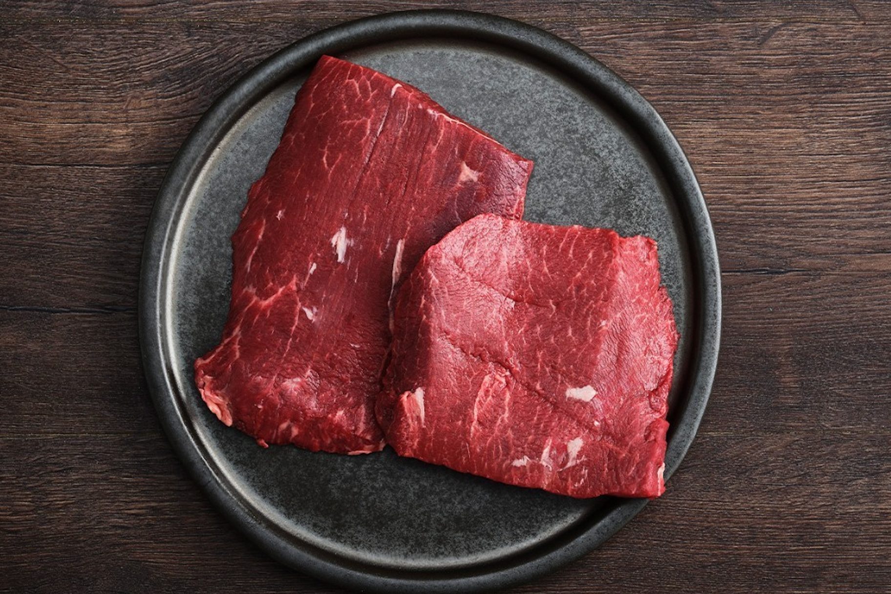 First Light Farms flat iron steak on black plate