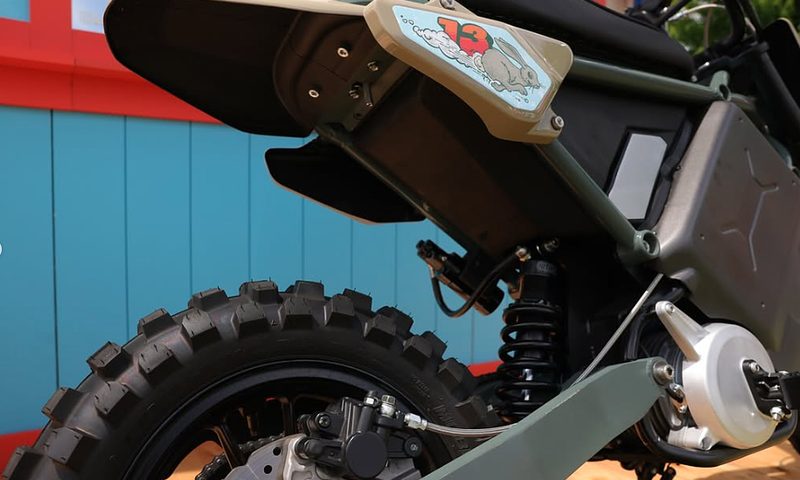 LiveWire previews 125cc equivalent EV trail motorcycle close up of knobby tire and rear suspension but no plate bracket or lights.