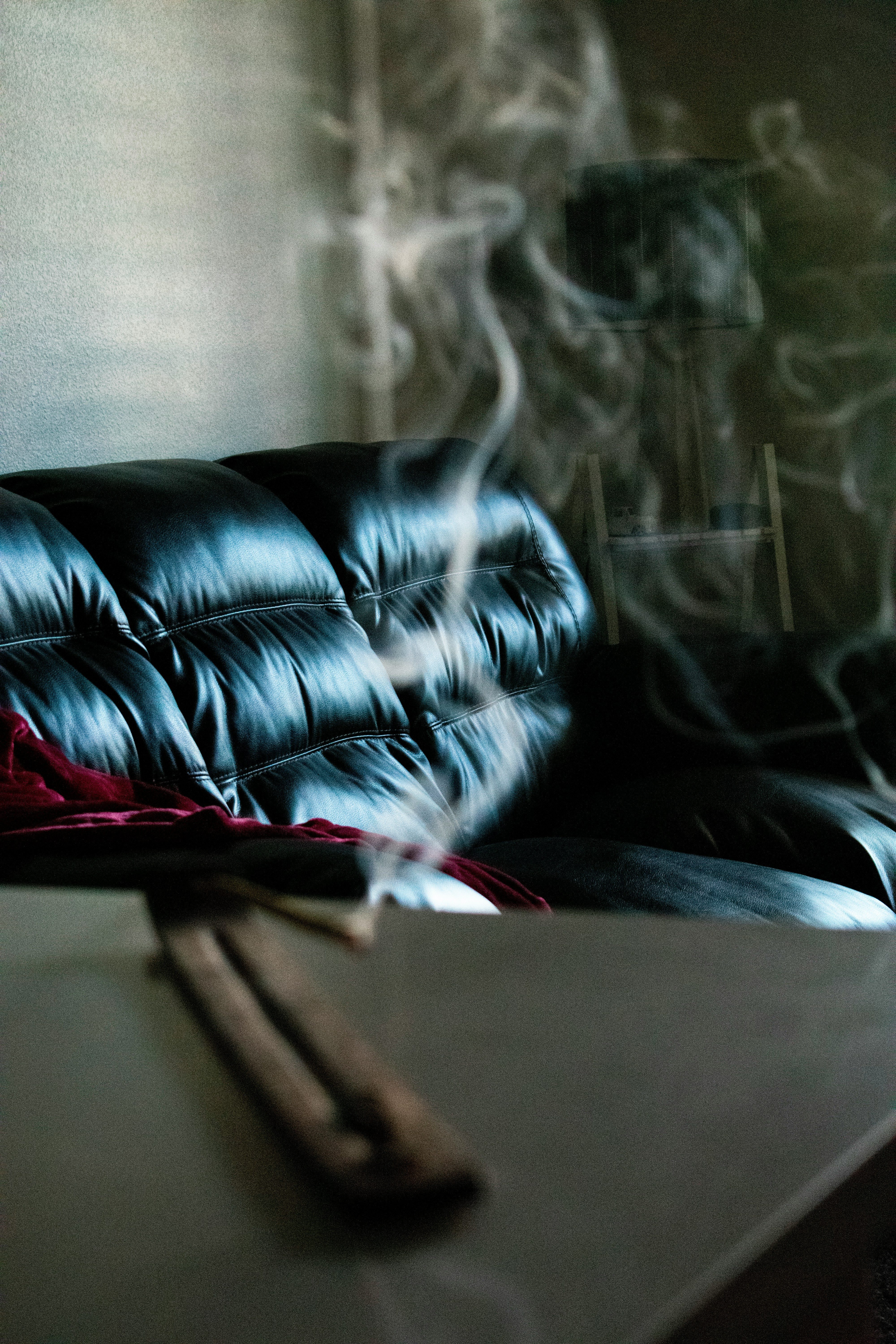 a leather chair with smoke in the foreground