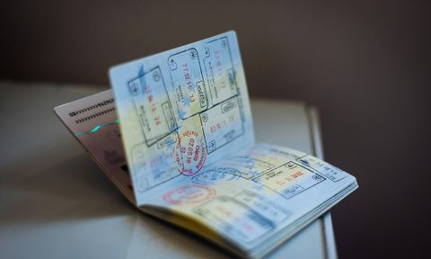 passport book on table open with stamps