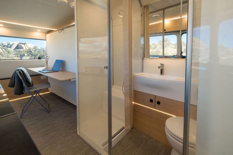 Bright, modern interior of the Pebble Flow luxury travel trailer.