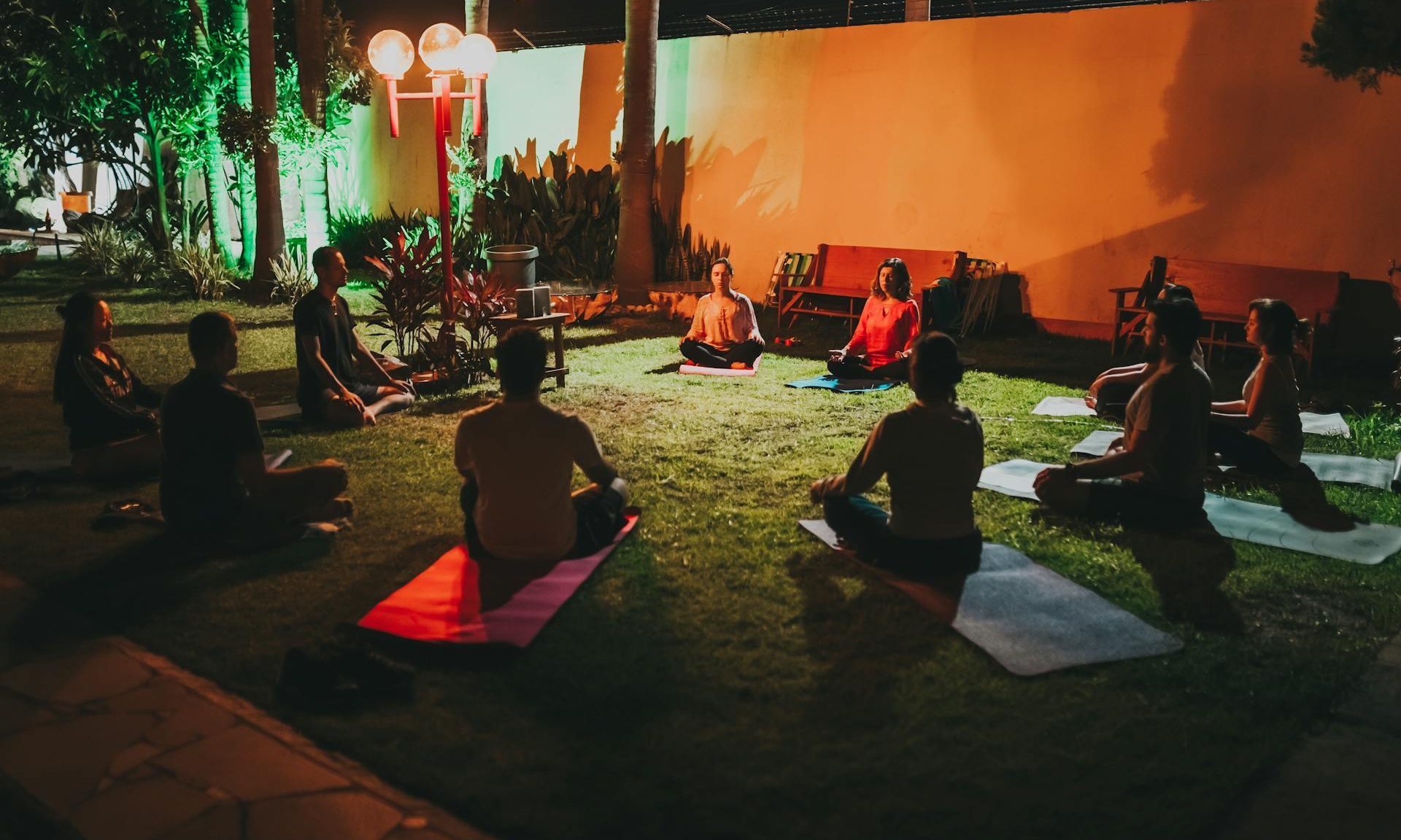people doing yoga class outside in circle