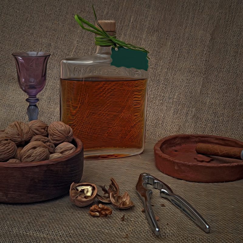 a bottle of alcohol next to nuts and a cigar