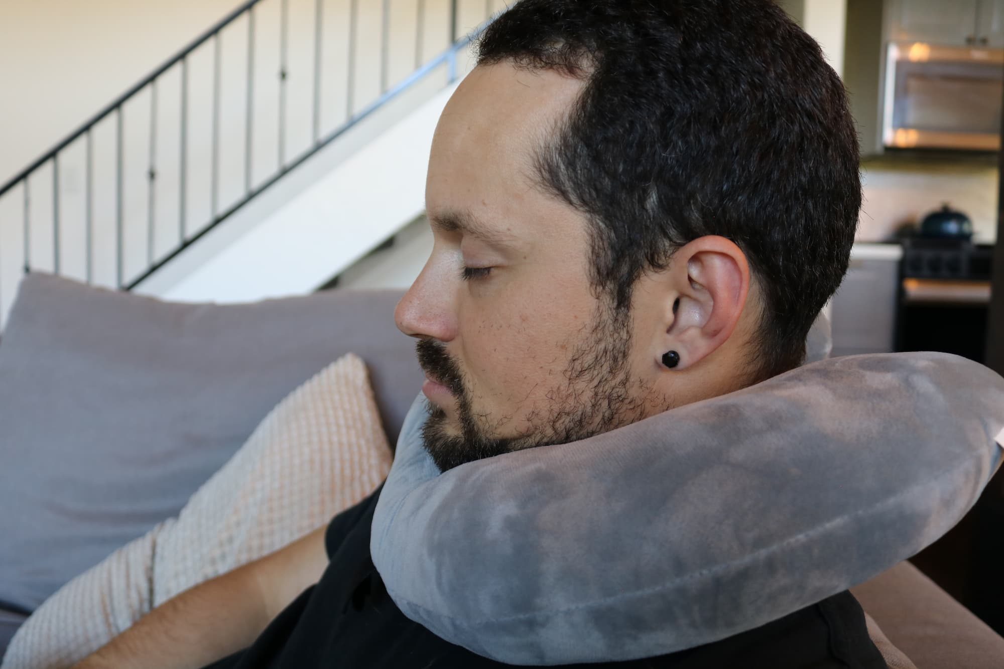 man sleeping with travel pillow