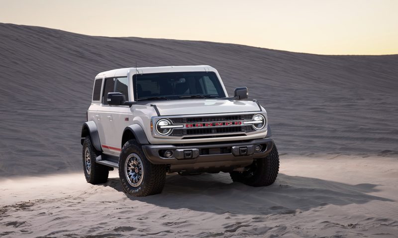 2026 Bronco with 60th Anniversary Package parked on desert sand right front three quarter view.