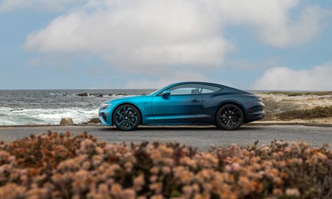 Bentley Ombre by Mulliner left profile view parked on asphalt by the sea.