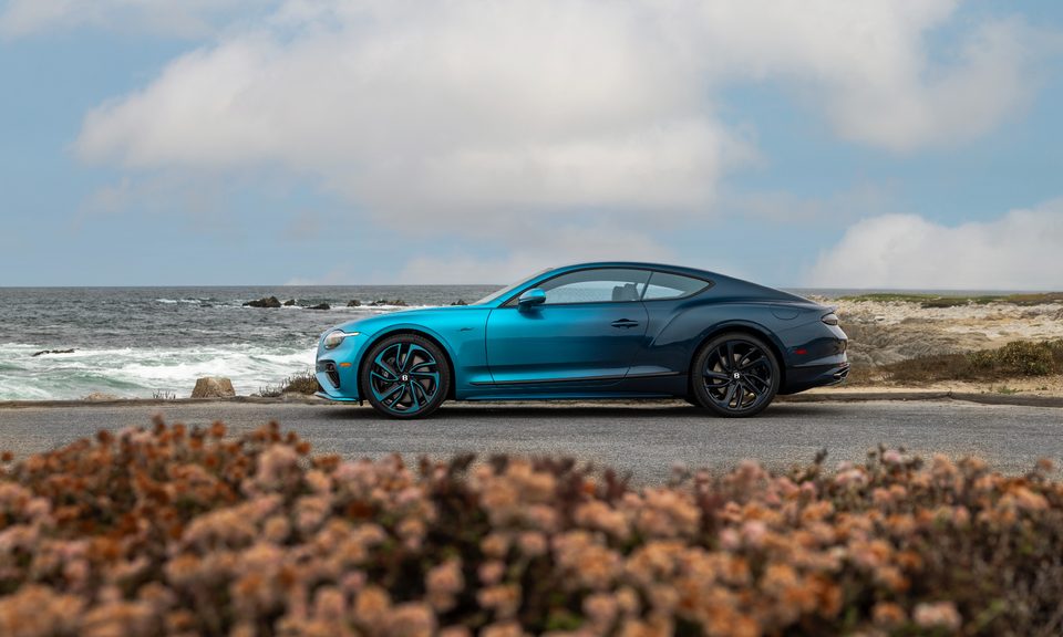 Bentley Ombre by Mulliner left profile view parked on asphalt by the sea.