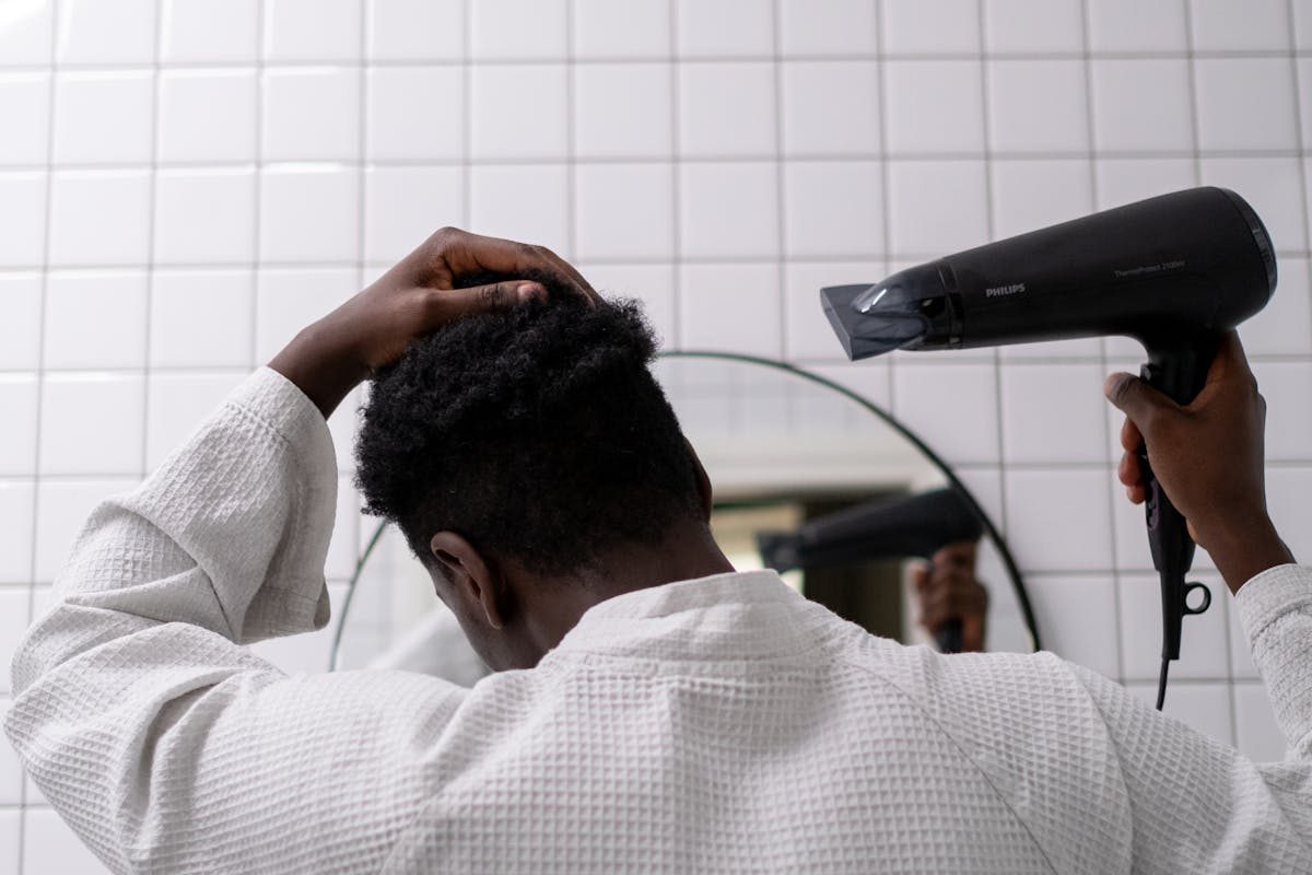 man drying hair in white robe