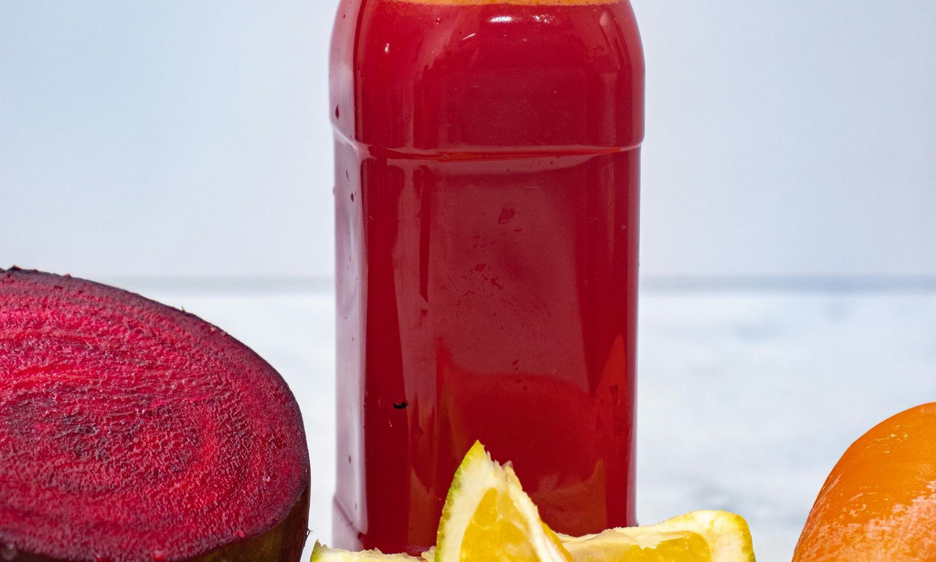 beet juice with carrot on table