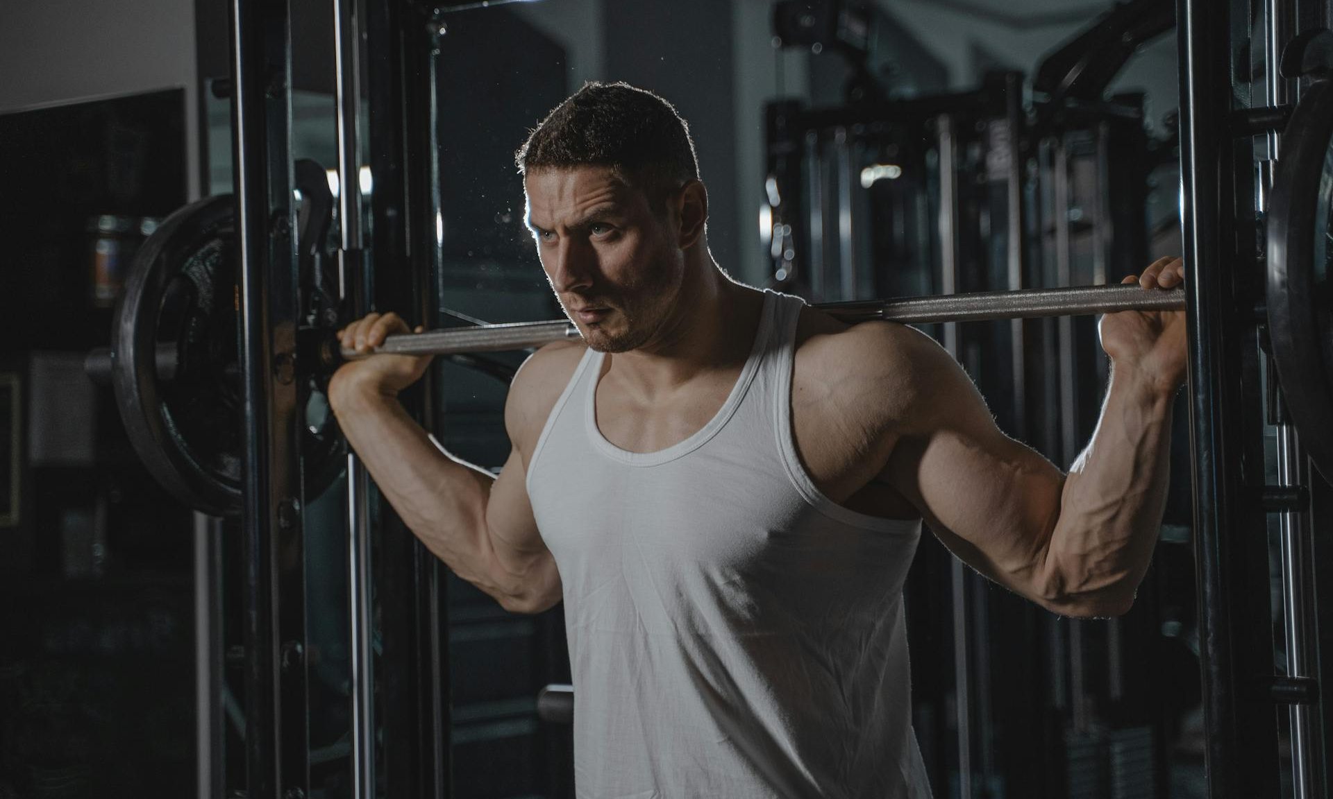 man with barbell squat weightlifting resistance training