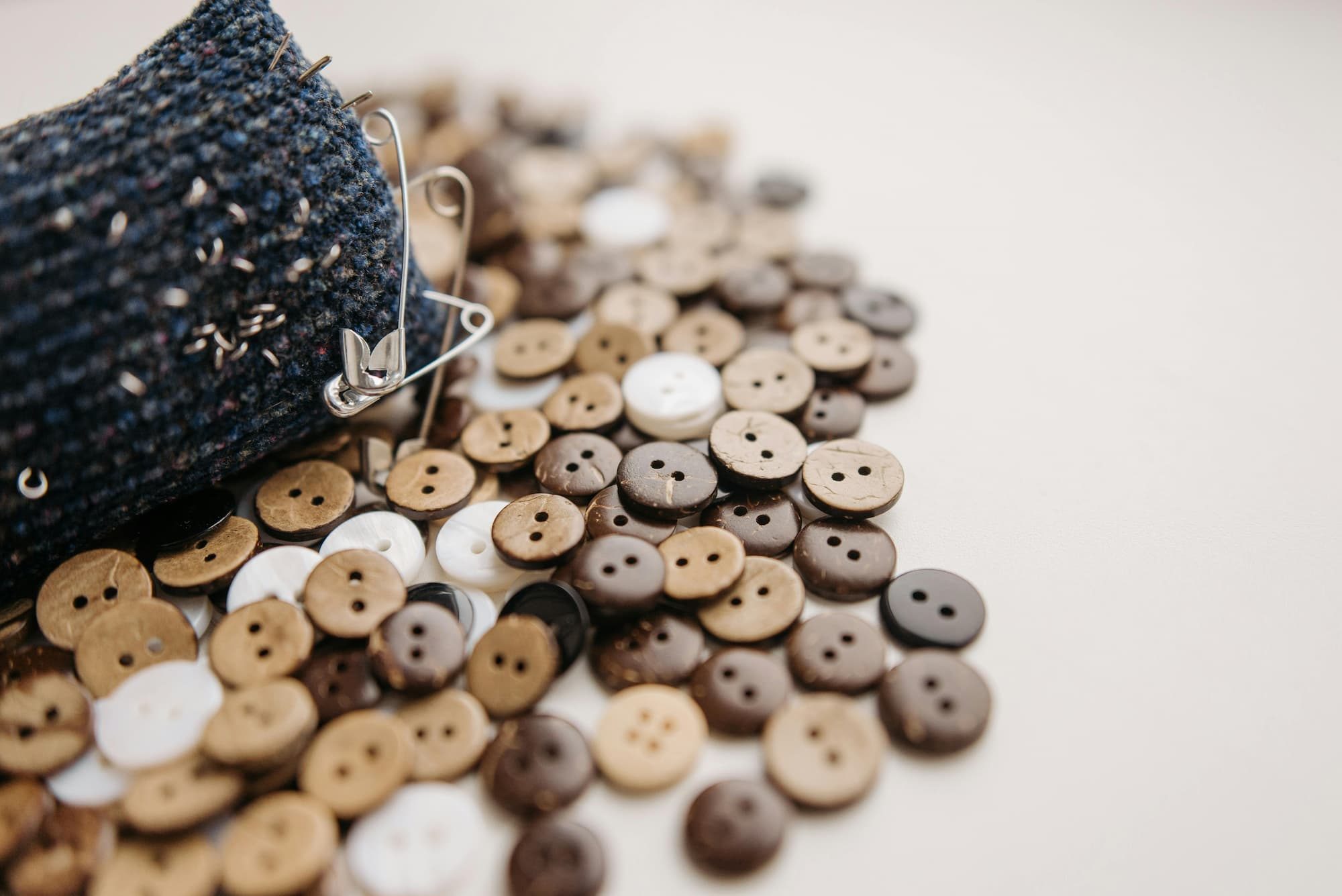 wooden buttons and safety pins on table