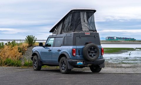 A Ford Bronco with an Ursa Minor B30 rooftop camper installed.