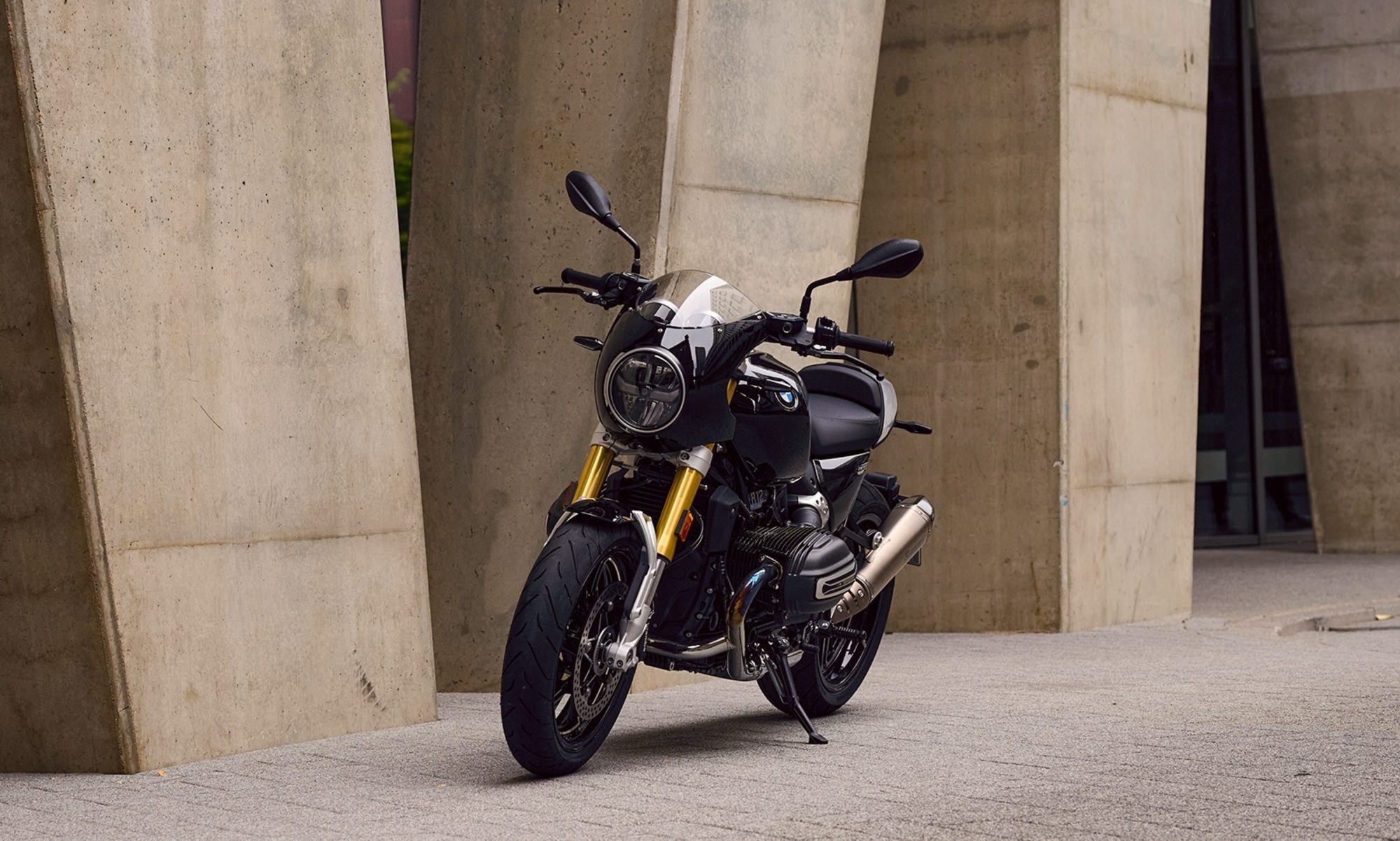 2026 BMW R 12 NineT with Tracker package parked on concrete next two a stone building.
