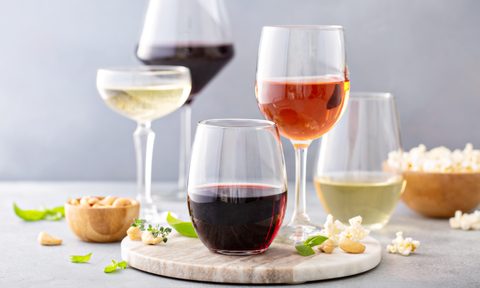 Red, white wine and rose in different glasses with snacks