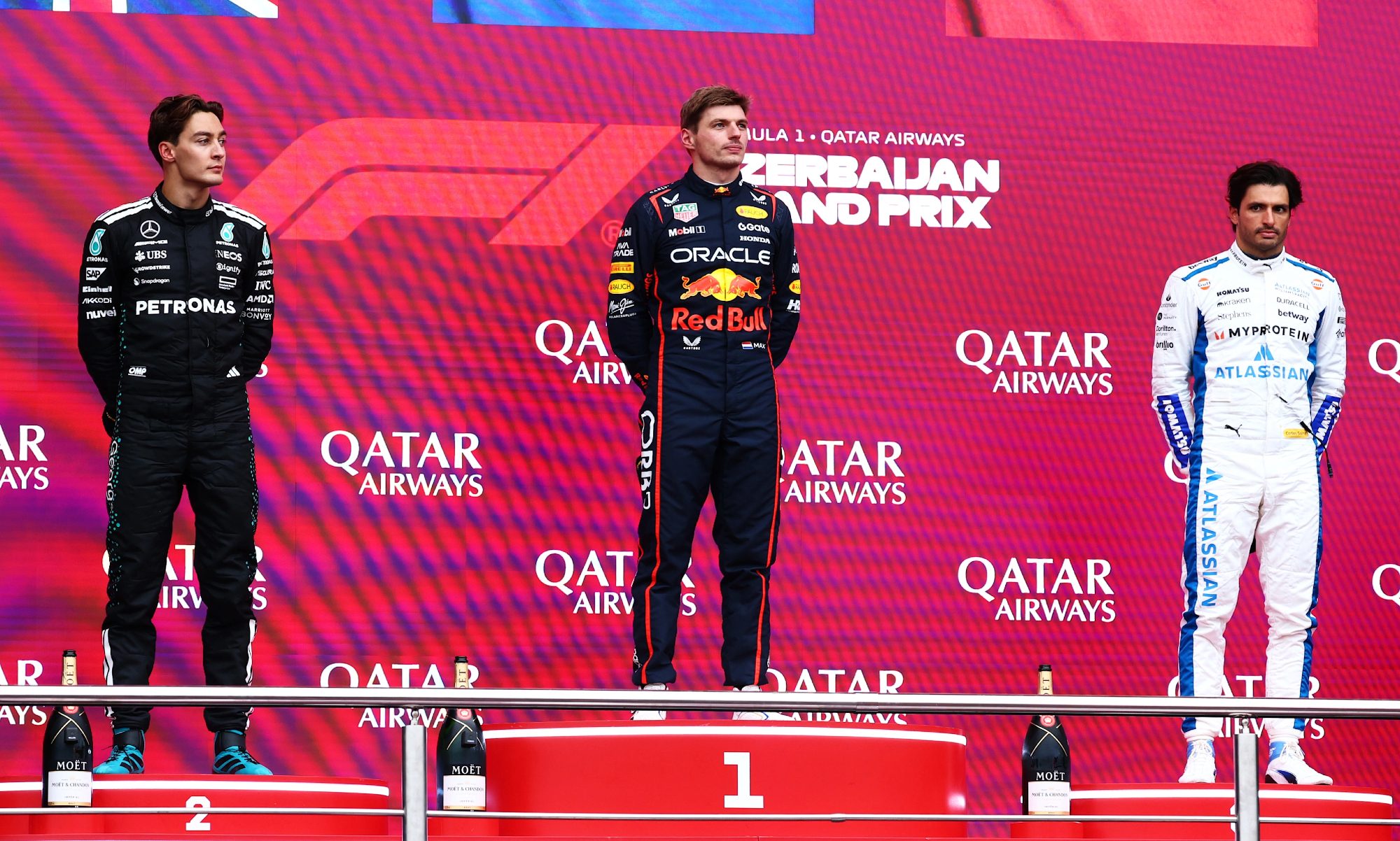 George Russell, Max Verstappen, and Carlos Sainz on winners podium for Azerbaijan Grand Prix.