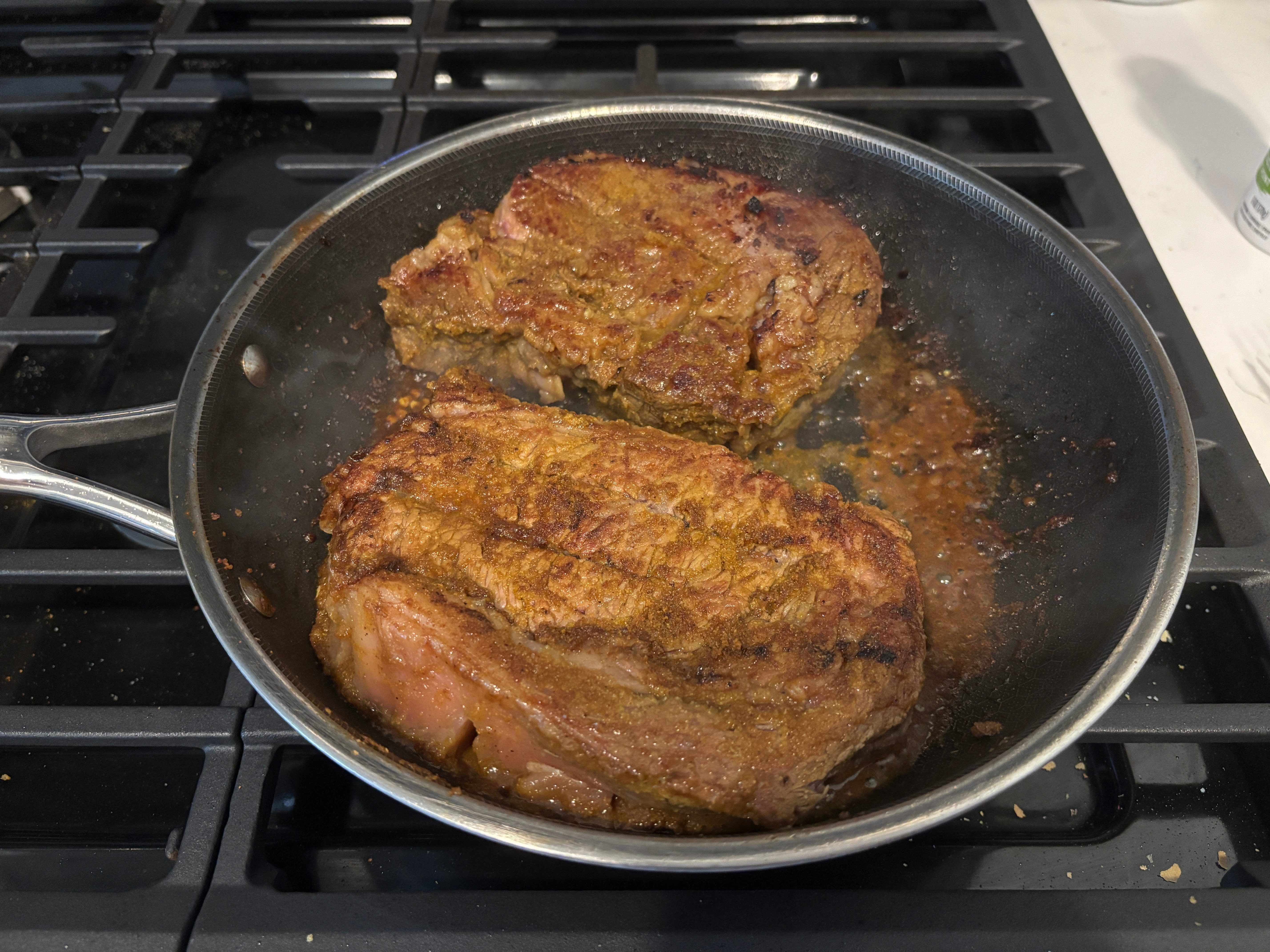cooking steaks on pan