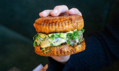 puff pastry burger held up by hand