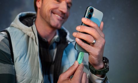 man inserting flash drive into his phone