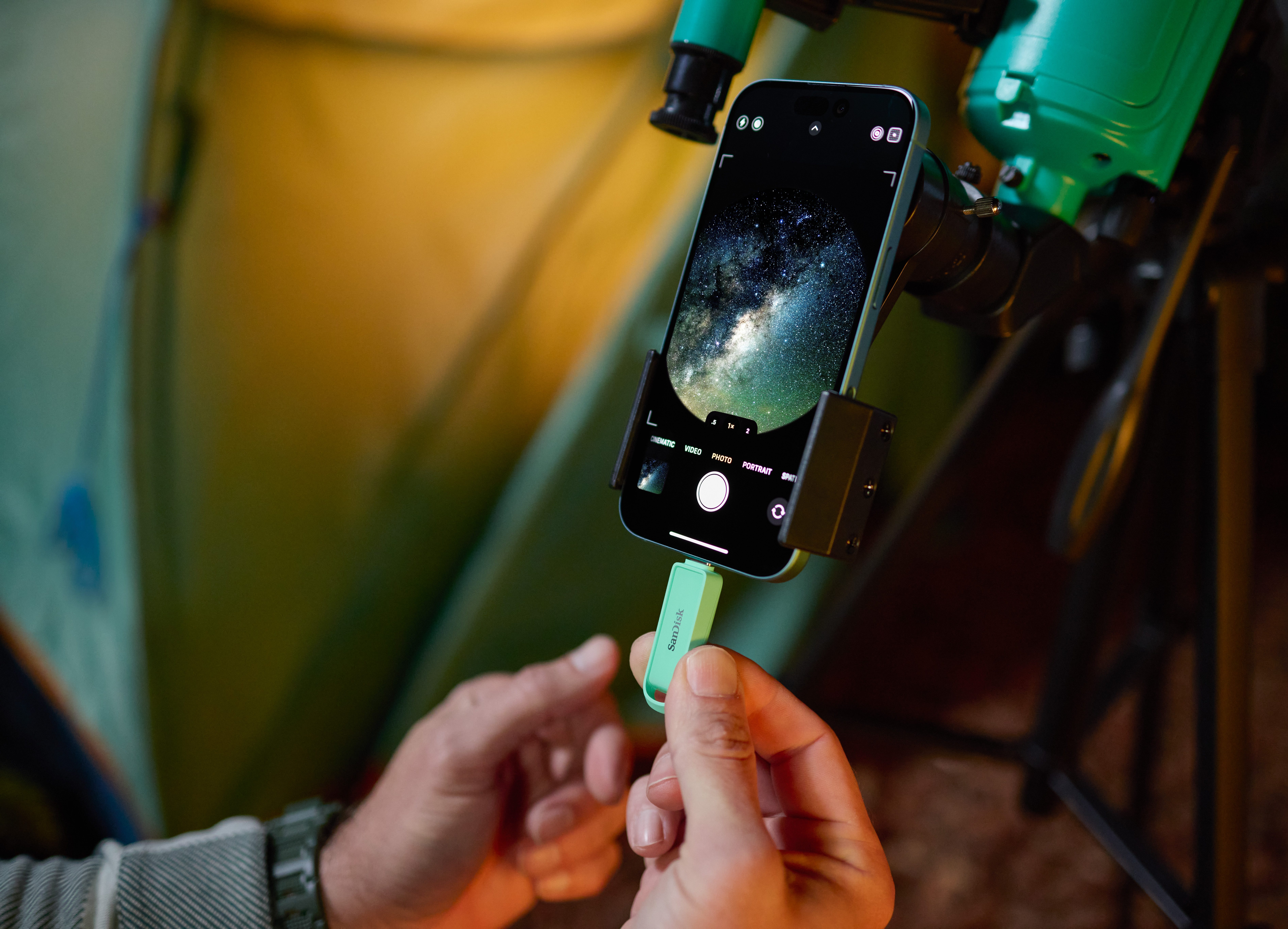 person inserting flash drive into their phone
