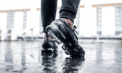 man wearing sneakers in rain