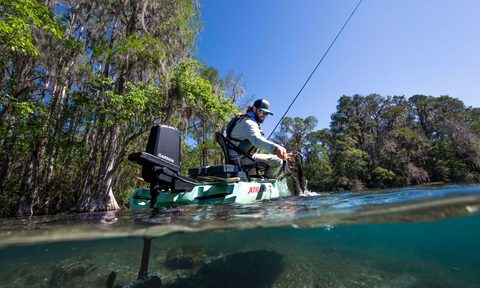 An angler in a fishing kayak setup with Garmin's Force Current wireless kayak propulsion system.
