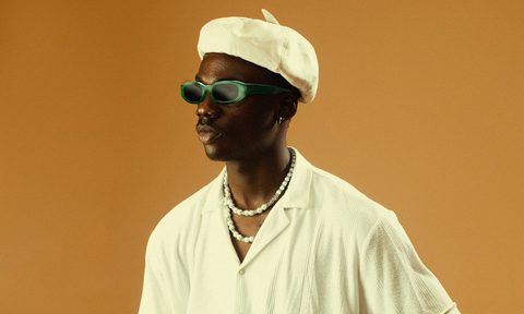 A man wearing the LGR for Cactus Flowers emerald sunglasses