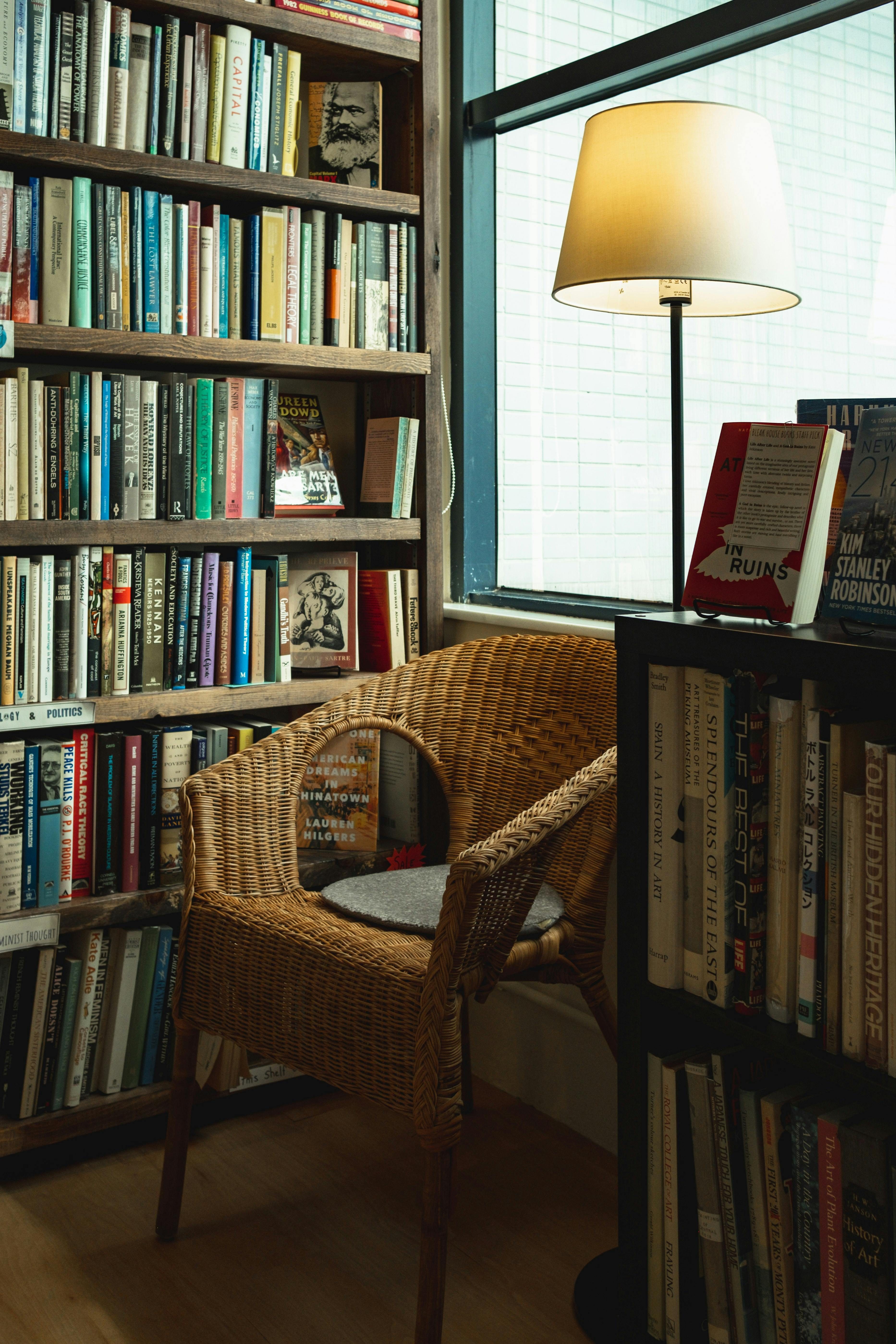 Brown chair beside bookshelf