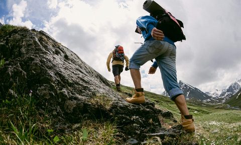 men hiking walking uphill.