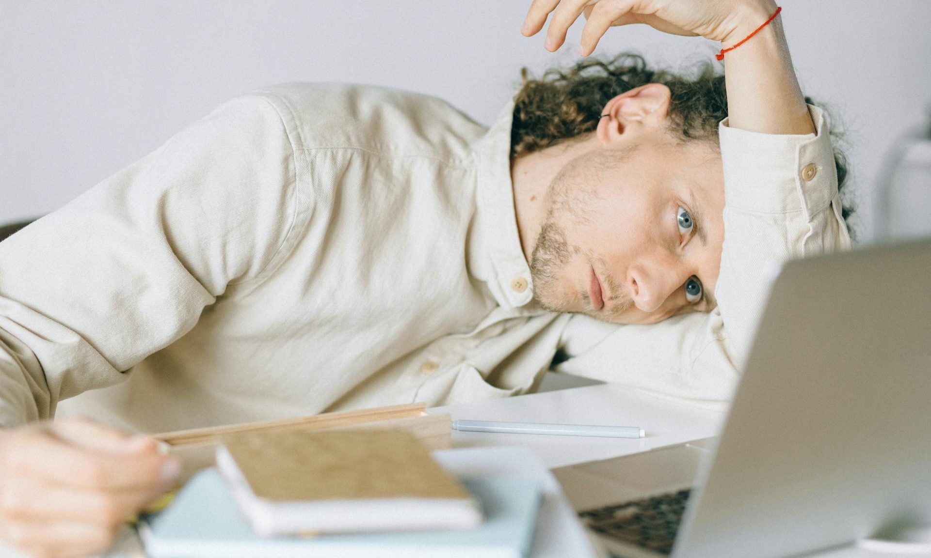 man tired burnout at work job desk