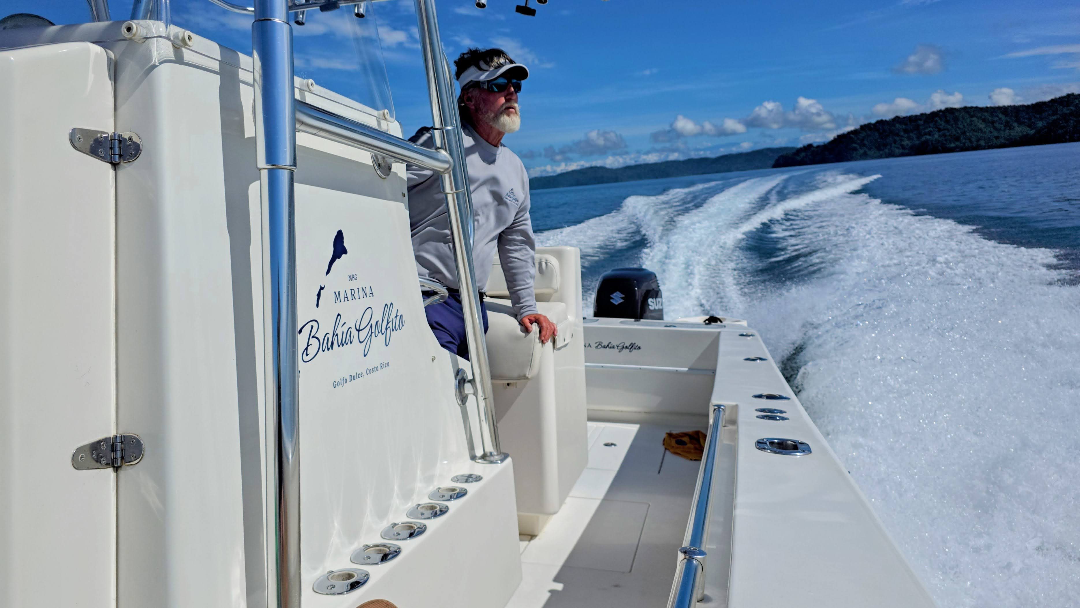 A tour guide looking out on the water from a boat