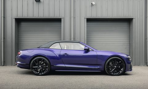 Bentley Continental GTC Speed in Violette finish parked in front of a garage right profile view.