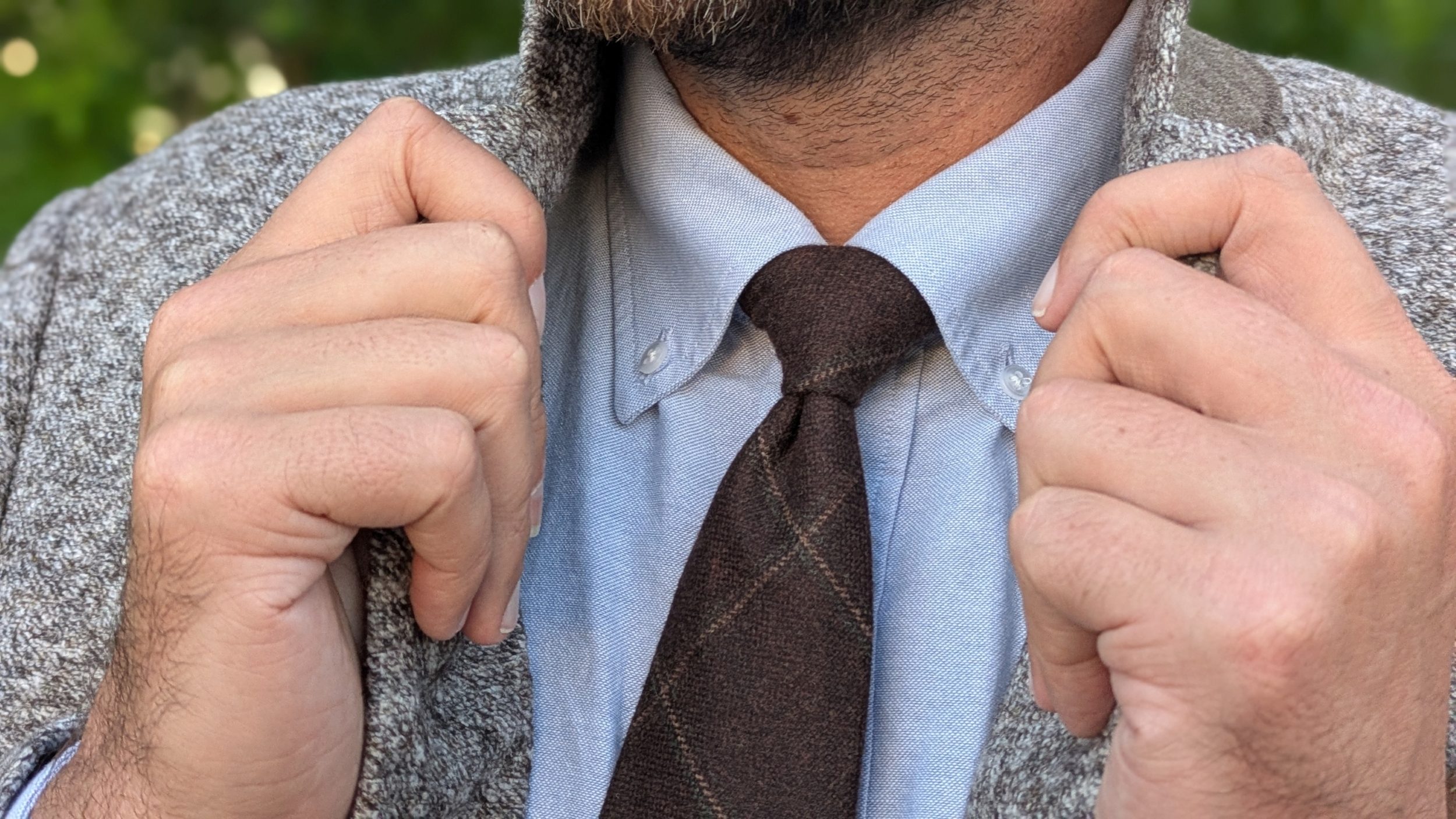 Brown sportcoat blue button down close up