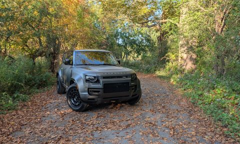 Front view of the 2025 Land Rover Defender 110 OCTA on a leafy trail