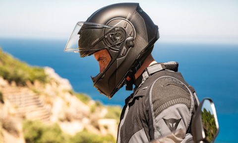 Person wearing a Cardo Beyond GTS helmet left profile shot.