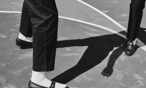 man playing basketball in loafers