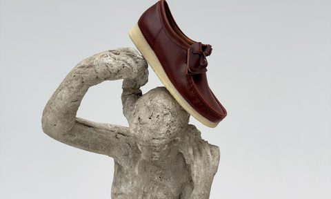 clarks x sandro shoe on statue