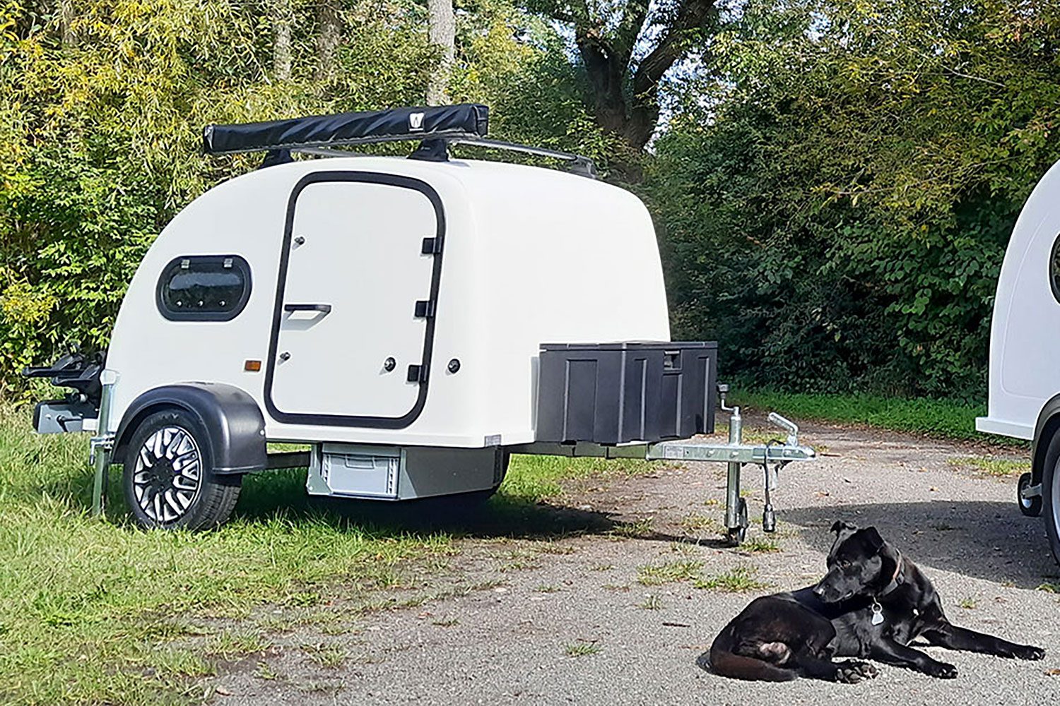 Kleox Festival Travel teardrop trailer parked in a grassy campsite.