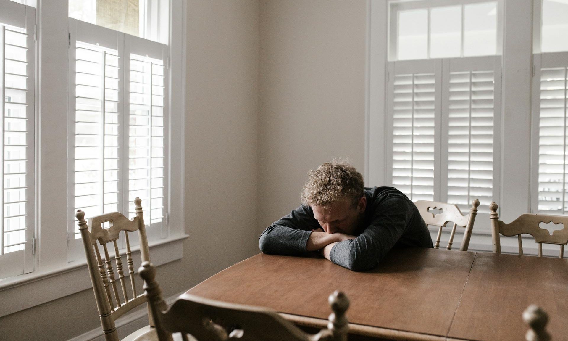 man at the table sad tired